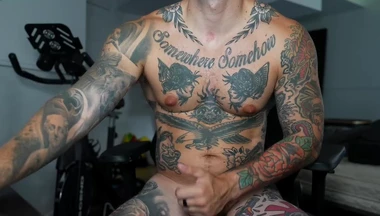 Heavily Tattooed Guy Cums on His Thigh