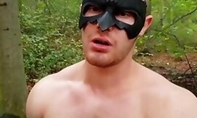 Muscular dude strokes his cock outdoors while wearing a mask